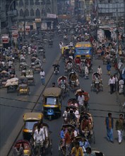 BANGLADESH, Dhaka, "Street scene from above with trishaws, people and bus shops "