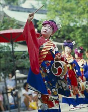 JAPAN, Honshu, Kyoto, Boy in costume with drum and stick at the Tanabata Festival