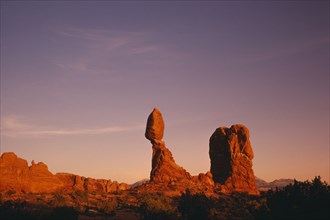 USA, Utah, Arches National Park, Balanced Rock formation seen in red evening light