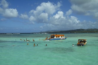 WEST INDIES, Tobago, Buccoo Reef, Nylon Pool with tourists swimming or standing in shallow water by