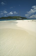 WEST INDIES, Puerto Rico, Yacht moored offshore between deserted beach and island