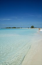 CUBA, Isla De Juventud, Cayo Largo, Playa Sirena with couple walking along the beach near the