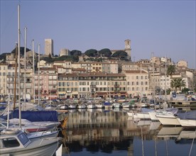 FRANCE, Provence Cote d’Azur, Alpes Maritime, Cannes castle above the harbour buildings with boats
