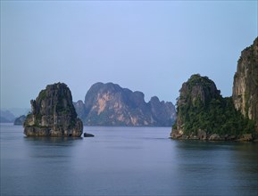 VIETNAM, North, Ha Long Bay, "Karst limestone islands rising from sea, green plants in rockface "
