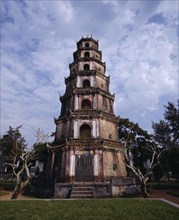 VIETNAM, Central, Hue, "Thien Mu Pagoda,tiered brickwork,trees & dead trunks,mottled sky "