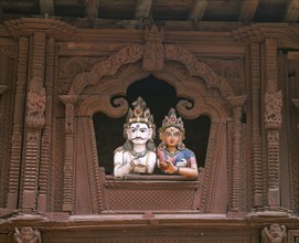 NEPAL, Kathmandu, Durbar Square.  Coloured carvings of Shiva and Parvati.