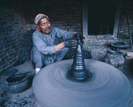 NEPAL, Bhaktapur, Local potter shaping vase on wheel