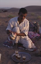 EGYPT, Sahara Desert , Berber guide pouring tea