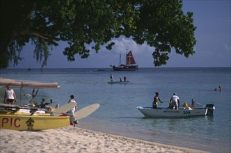 WEST INDIES, Barbados, St James, Holetown. Various boats and tourist water activities beside beach.