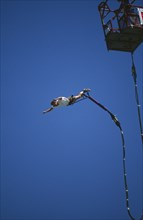 SPORT,  , Bungee Jumping, Man diving from a crane with elastic cord tied to his ankles
