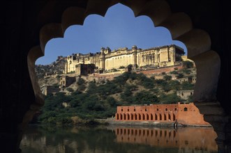 INDIA, Rajasthan, Amber, Amber Palace Fort near Jaipur situated on hillside above lake framed by