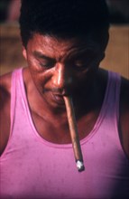 CUBA, Pinar Del Rio, Tobacco, Man smoking in cigar factory