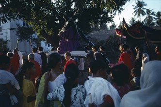 INDIA, Goa, Margao, Easter Procession.  Men carrying statue of Christ at calvary through street and