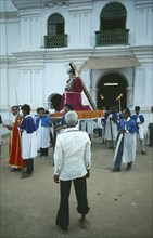 INDIA, Goa, Easter , Procession outside village church with statue of Christ being carried out of