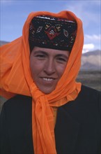 CHINA, Xinjiang, Tashkurgan, Portrait of a Kazakh woman wearing an orange headscarf