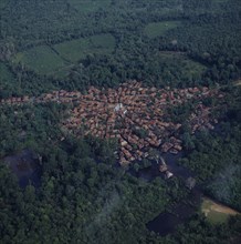 INDONESIA, Sumatra, Aerial view of small town built around a mosque showing radial formation of