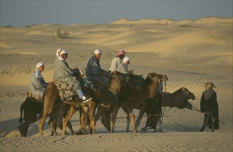 TUNISIA, Sahara Desert, Men riding Camels