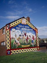N.IRELAND,  , Belfast, Ardoyne mural depicting traditional Gaelic sports.
