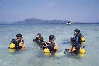 THAILAND, Phuket, Koh Hi, Also known as Coral Island. Tourists having scuba diving lessons in the