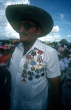 CUBA, Santiago, Veteran at memorial with shirt adorned with medals