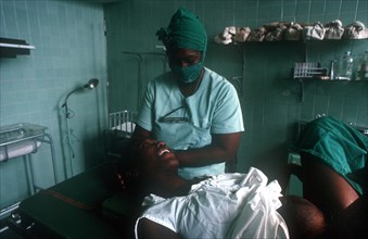 CUBA, Havana, Pregant woman in advanced labour being attended by nurse in the delivery suite