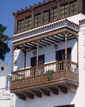 SPAIN, Canary Islands, Tenerife, Traditional ornate wooden balcony on whitewashed house