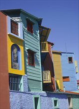 ARGENTINA, Buenos Aires, La Boca, Detail of brightly coloured wooden buildings set against a deep