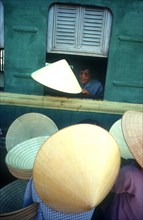 VIETNAM, Hue, Hat sellers beside train.