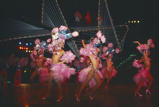 CUBA, Havana Province, Havana, Female Club Tropicana dancers on stage with singers on overhead