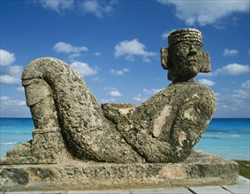 MEXICO, Quintana Roo, Cancun, Chac-Mool statue with the sea beyond
