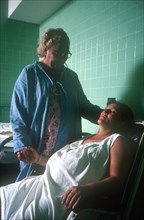 CUBA, Havana, Pregnant woman in labour being attended by hospital nurse
