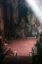 VIETNAM, Danang, Cave Temple in the Marble Mountains.  Looking towards altar and seated Buddha