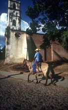 CUBA, Sancti Spiritus, Trinidad, Horseman on cobbled street