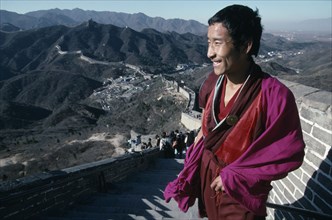 CHINA, Beijing Division, Badaling, Tibetan Monk standing at the top of steps on The Great Wall