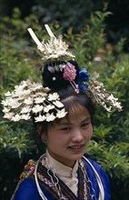 CHINA, Guizhou Province, Kaili , Miao girl in traditional costume and headress with silver