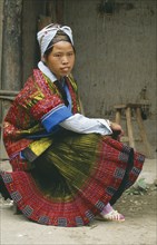 CHINA, Guizhou Miao Girl, Kaili, Seated Miao girl in festival dress