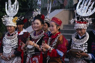CHINA, Guizhou, Kaili, Miao girls in traditional festival costume with silver head-dresses