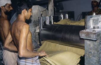 INDIA, Kerala, Industry, Workers in rubber factory.