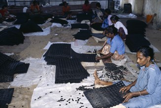 INDIA, Kerala , Industry, Female workers on floor of factory making rubber mats.