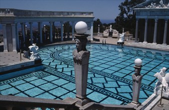 USA, California, Randolph Hearst Castle, Greek Pool with columned surround and people gathered in