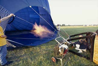 SPORT, Air  , Ballooning, Inflating balloon with gas flame on the ground in Hedcorn Kent.