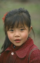 CHINA, Sichuan Province, Dazu , Portrait of young Chinese girl wearing red
