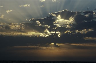WEATHER , Climate, Clouds, Sun beams through clouds over the sea