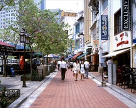 SINGAPORE, Riverside, "Boat Quay, people walking along red pavement with outdoor cafes & shops "