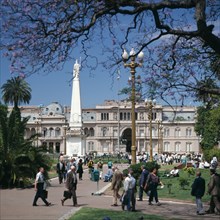 ARGENTINA, Buenos Aires, "Plaza de Mayo, Piramide de Mayo, Casa Rosada, people, Jacaranda tree "
