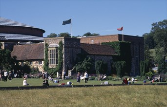 ENGLAND, East Sussex, Glyndebourne, "New theatre, exterior with audience members crossing the lawn