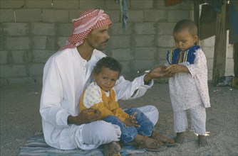 EGYPT, People, Bedouin man with his two young children.