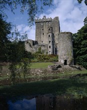 IRELAND, County Cork, Blarney, "Blarney Castle, view of grey stone castle with garden in front "