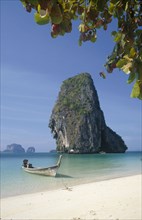 THAILAND, Krabi Province, Phra Nang Beach, Long tail boat in clear calm blue water at the edge of