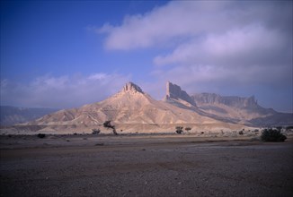 SAUDI ARABIA, Eastern Province, Howtah, Desert landscape with triangular rock formation and
